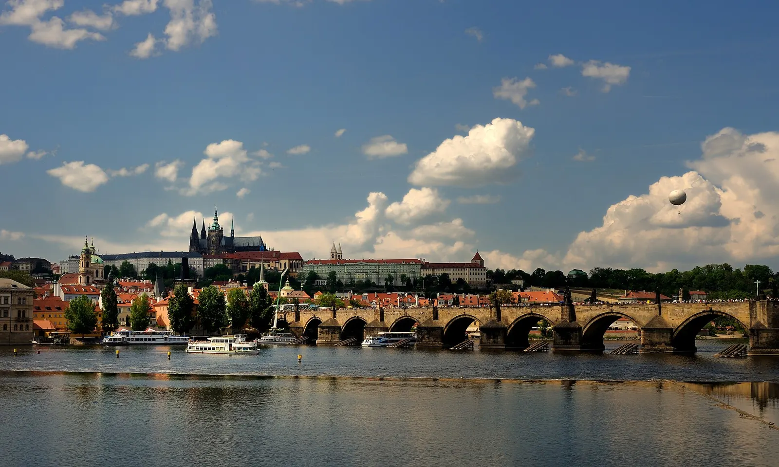 Charles Bridge and Prague Castle under summer clouds