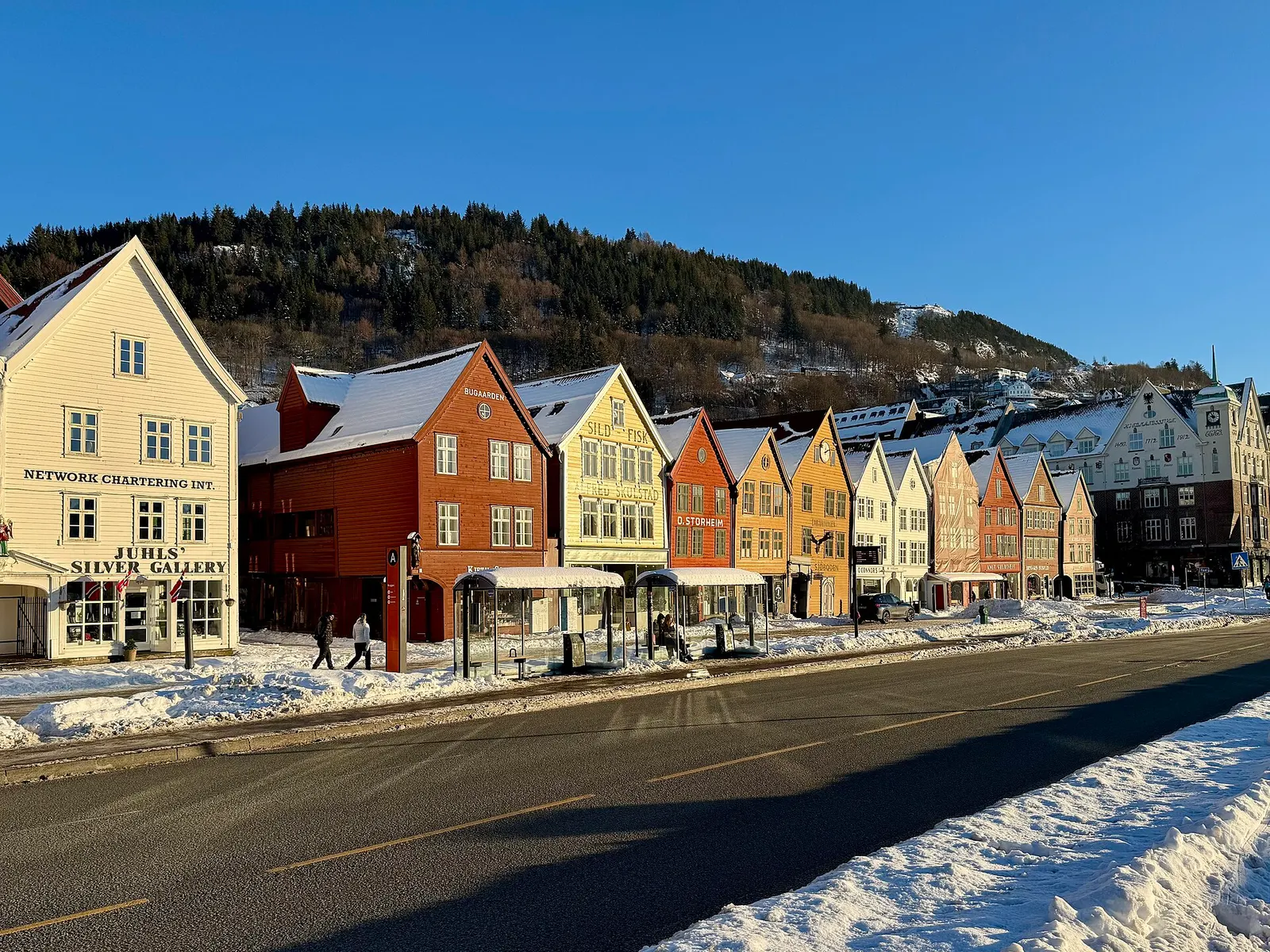 Bryggen wharf in Bergen with snow on the hills behind