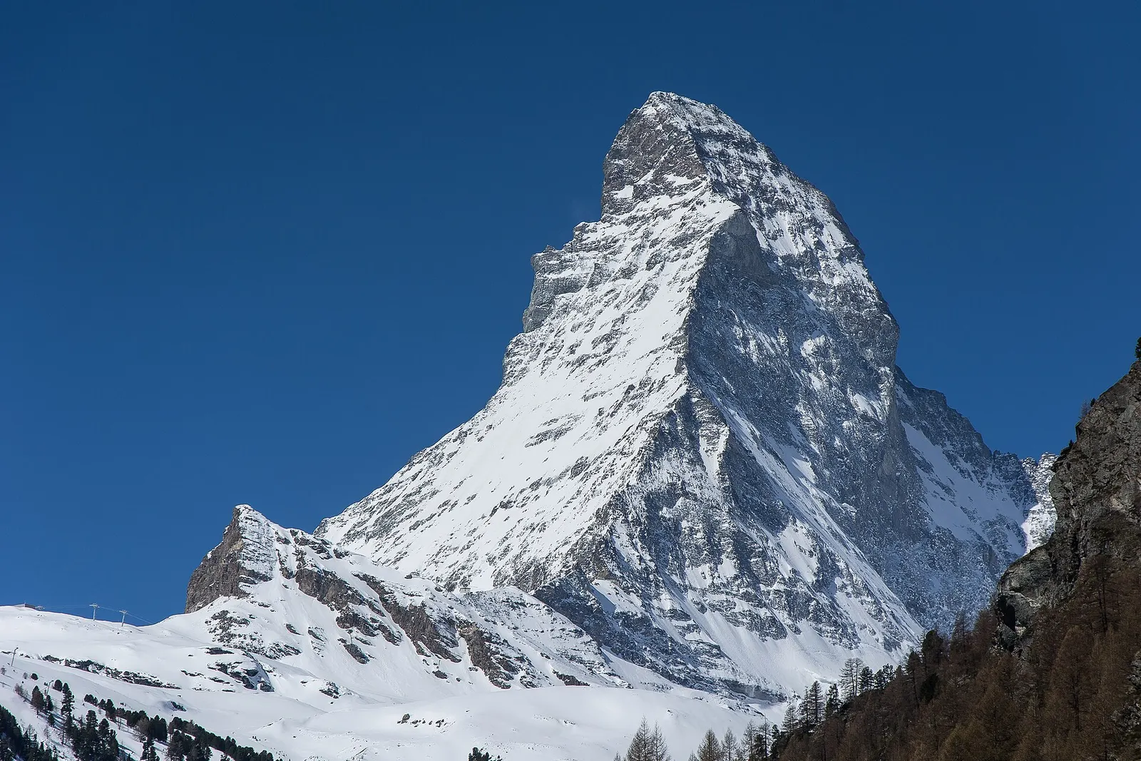 Snow-covered Matterhorn against a deep blue sky