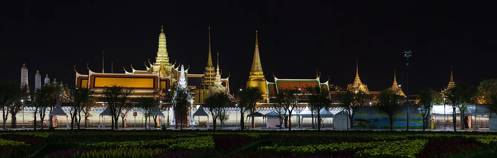 Golden spires of Wat Phra Kaew in Bangkok lit at night