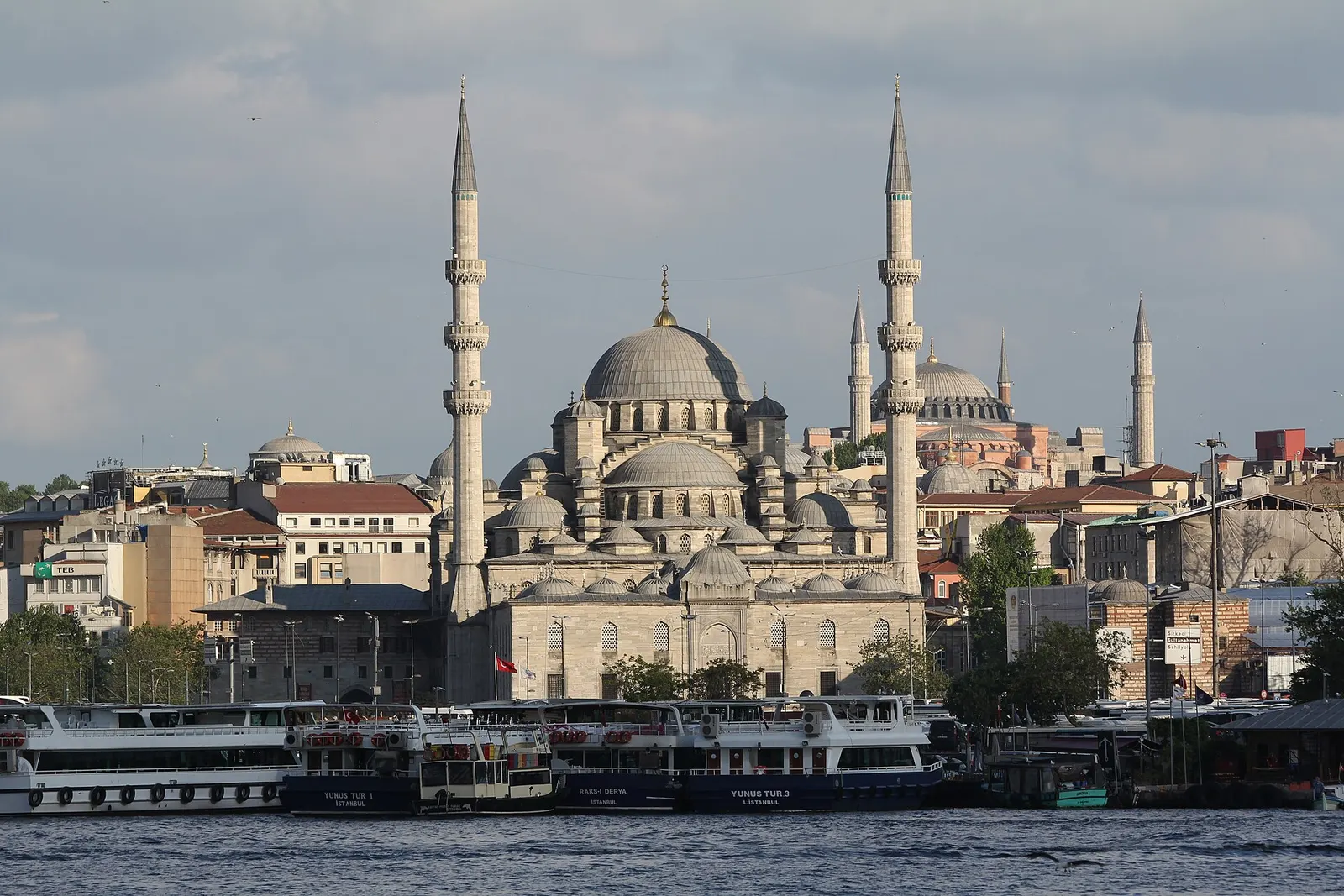 New Mosque in Istanbul seen from the Bosphorus with ferries in front