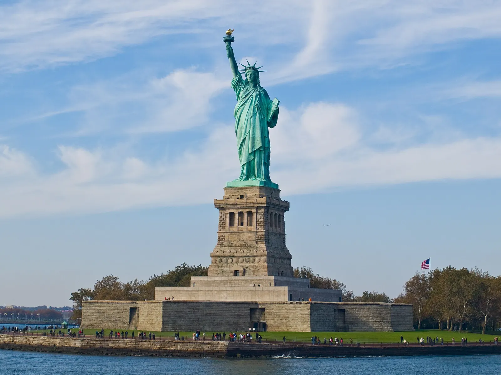 Statue of Liberty on Liberty Island under a blue sky