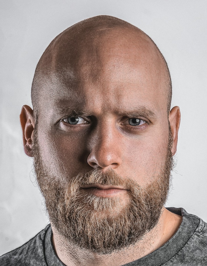 Japanese passport file our tool made, 35 x 45 mm: bald, bearded man in a grey crew-neck top on his own light grey wall