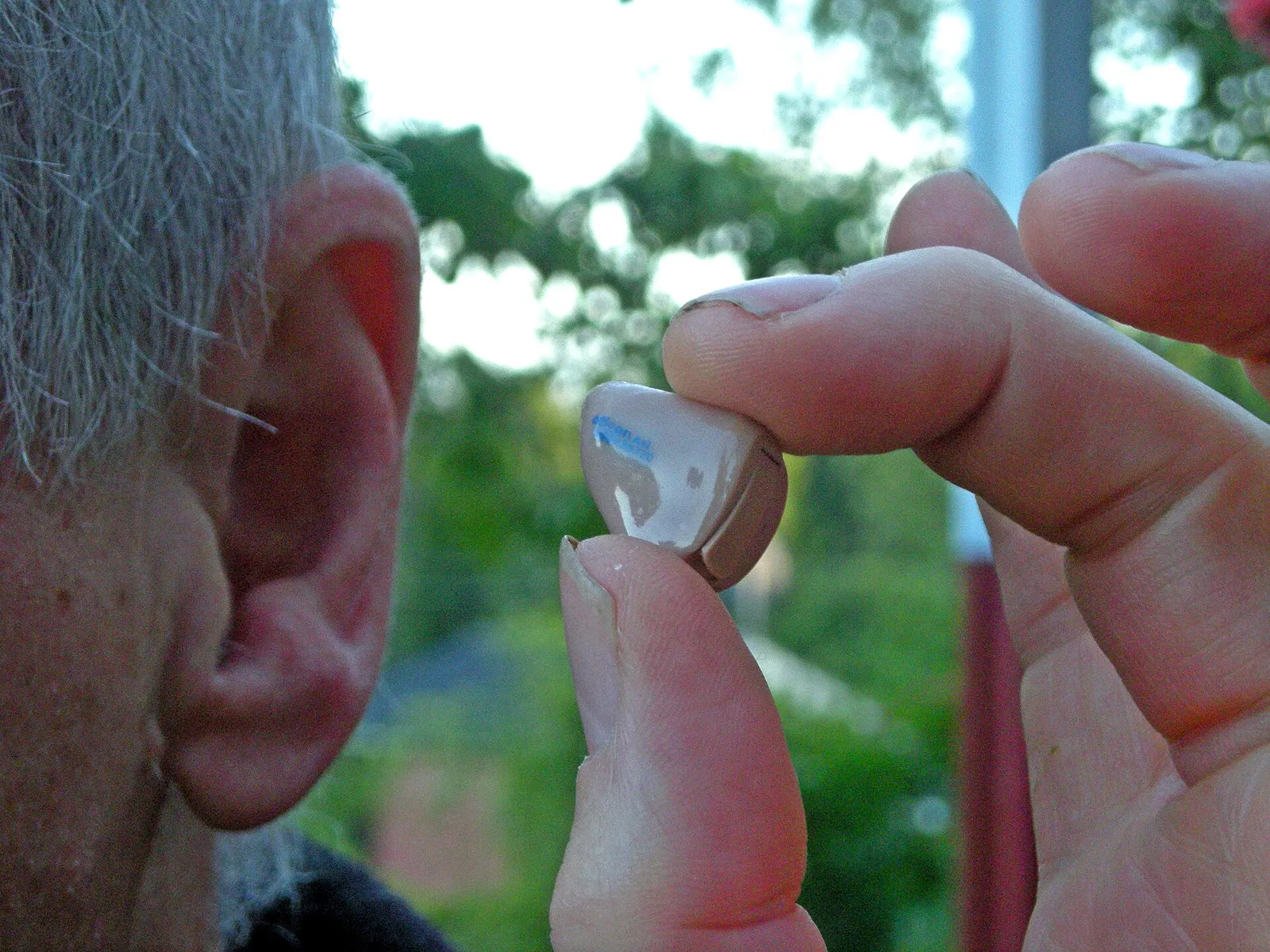 Small in-ear hearing aid being fitted