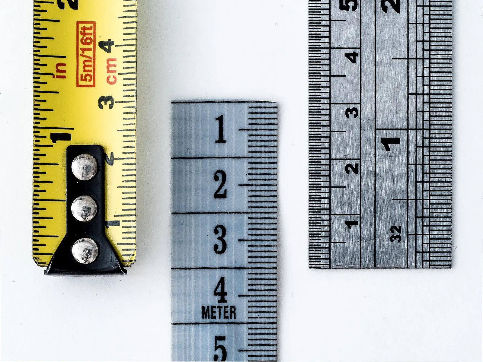 Three rulers side by side showing centimetres and inches