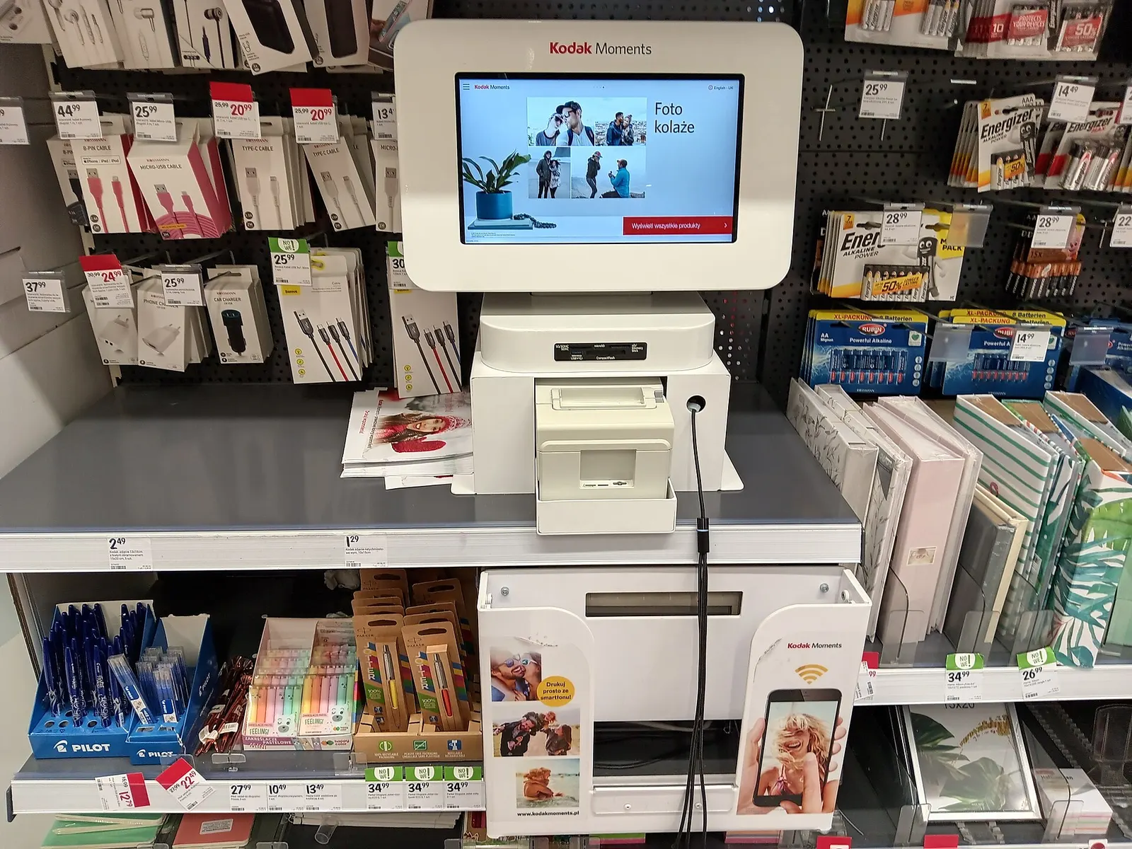 Self-service photo print kiosk in a shopping centre aisle